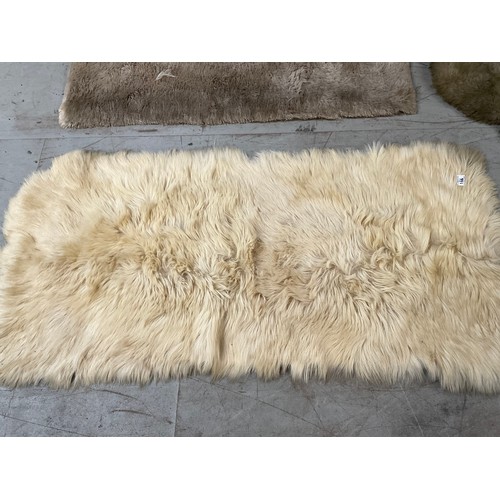 166 - 3 FUR RUGS AND A ANIMAL SKIN EXAMPLE