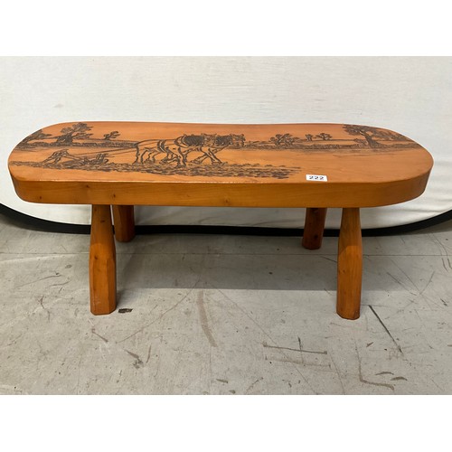 222 - PINE COFFEE TABLE WITH CARVING TO TOP OF HORSES PLOUGHING A FIELD L34” H15” D14”