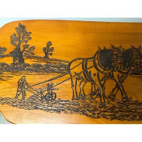 222 - PINE COFFEE TABLE WITH CARVING TO TOP OF HORSES PLOUGHING A FIELD L34” H15” D14”