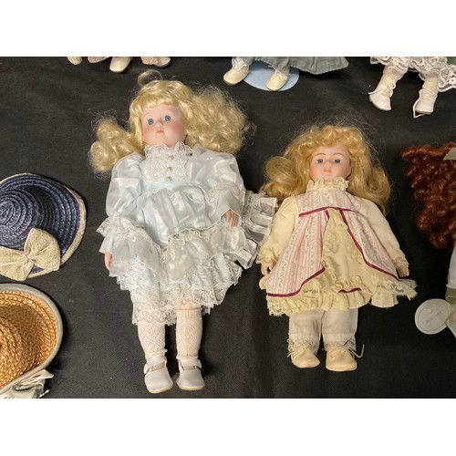 133 - A BOX OF COLLECTORS PORCELAIN DOLLS WITH STANDS AND ACCESORIES