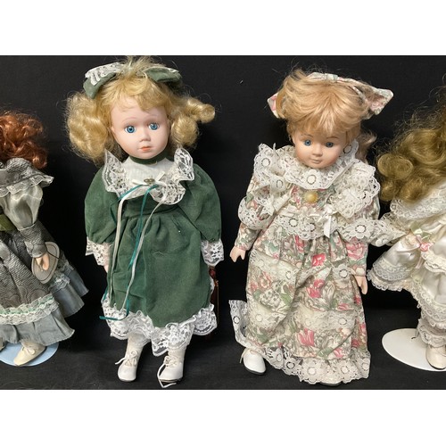 133 - A BOX OF COLLECTORS PORCELAIN DOLLS WITH STANDS AND ACCESORIES