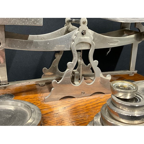 103 - LARGE SET OF EDWARDIAN  PARCEL SCALES AND WEIGHTS ON OAK BASE