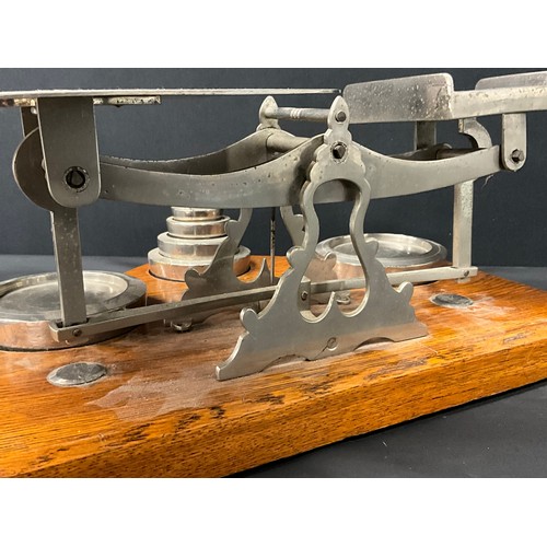 103 - LARGE SET OF EDWARDIAN  PARCEL SCALES AND WEIGHTS ON OAK BASE