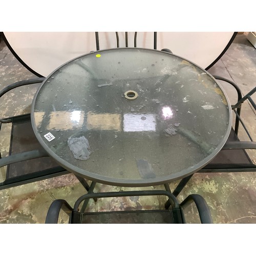 225 - METAL CIRCULAR GLASS TOPPED GARDEN TABLE AND 4 MATCHING CHAIRS