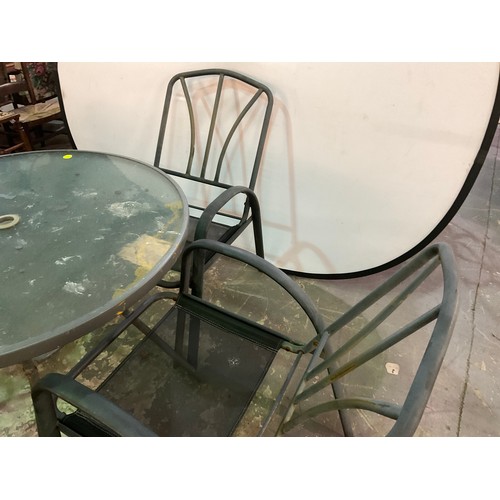 225 - METAL CIRCULAR GLASS TOPPED GARDEN TABLE AND 4 MATCHING CHAIRS