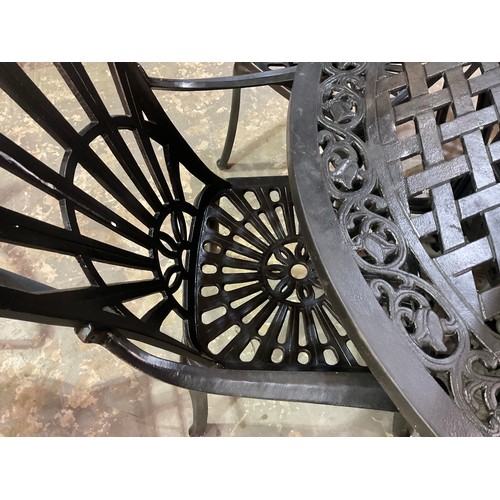 226 - LAGE CIRCULAR METAL GARDEN TABLE WITH PARASOL AND 3 MATCHING AND 2 ODD CHAIRS