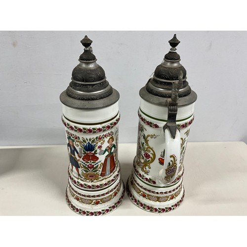 73 - PAIR OF LARGE GERMAN HAND PAINTED STEINS DECORATED COMPLETE WITH COVER H13