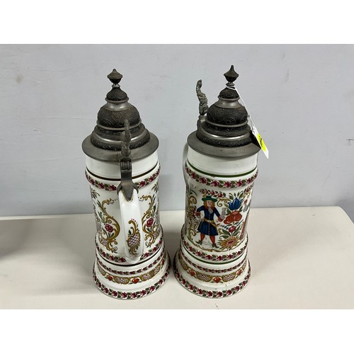 73 - PAIR OF LARGE GERMAN HAND PAINTED STEINS DECORATED COMPLETE WITH COVER H13