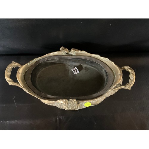 87 - ORNATE HEAVY BRASS TWIN HANDLED JARDINERE SUPPORTED ON FOUR FEET COMPLETE WITH LINER L16
