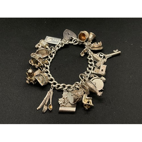 4 - HALLMARKED SILVER CHARM BRACELET WITH 22 CHARMS SILVER & WHITE METAL TW 85.8G - ENGLISH HALLMARK SIL... 