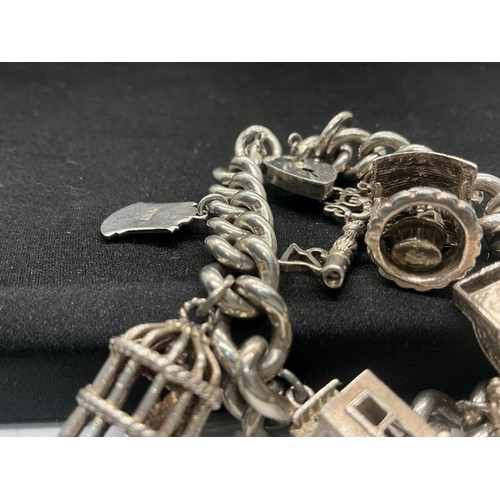 6 - HALLMARKED SILVER CHARM BRACELET WITH 9 SILVER & WHITE METAL CHARMS W68.6G - LOCKET IS ENGLISH HALLM... 