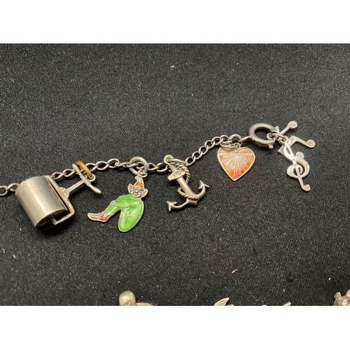 8 - 2 SILVER CHARM BRACELETS UNMARKED CHAIN BUT TESTED WITH A TOTAL OF 33 SILVER CHARMS W83.6G - 1 CHARM... 