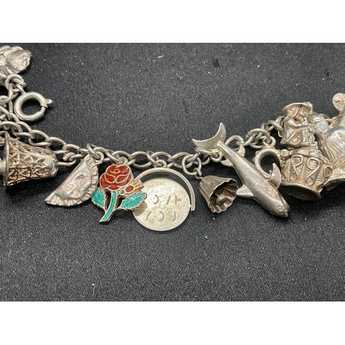 8 - 2 SILVER CHARM BRACELETS UNMARKED CHAIN BUT TESTED WITH A TOTAL OF 33 SILVER CHARMS W83.6G - 1 CHARM... 