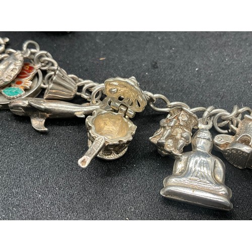 8 - 2 SILVER CHARM BRACELETS UNMARKED CHAIN BUT TESTED WITH A TOTAL OF 33 SILVER CHARMS W83.6G - 1 CHARM... 