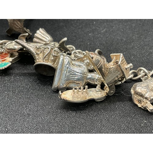 8 - 2 SILVER CHARM BRACELETS UNMARKED CHAIN BUT TESTED WITH A TOTAL OF 33 SILVER CHARMS W83.6G - 1 CHARM... 