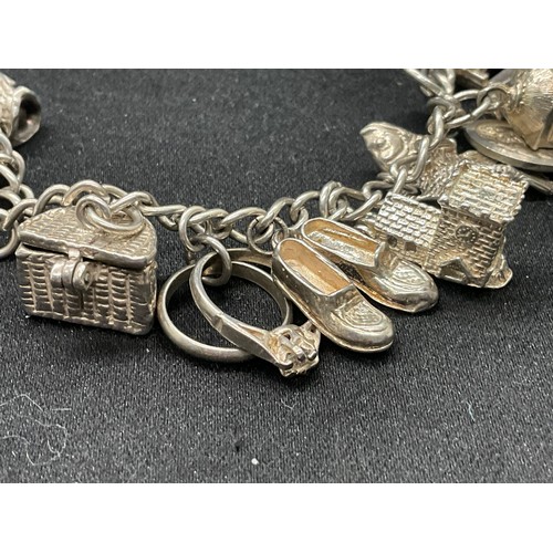 8 - 2 SILVER CHARM BRACELETS UNMARKED CHAIN BUT TESTED WITH A TOTAL OF 33 SILVER CHARMS W83.6G - 1 CHARM... 
