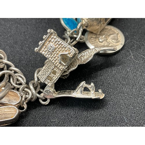 8 - 2 SILVER CHARM BRACELETS UNMARKED CHAIN BUT TESTED WITH A TOTAL OF 33 SILVER CHARMS W83.6G - 1 CHARM... 