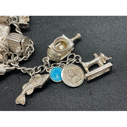8 - 2 SILVER CHARM BRACELETS UNMARKED CHAIN BUT TESTED WITH A TOTAL OF 33 SILVER CHARMS W83.6G - 1 CHARM... 
