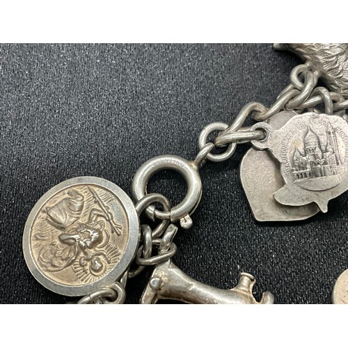 8 - 2 SILVER CHARM BRACELETS UNMARKED CHAIN BUT TESTED WITH A TOTAL OF 33 SILVER CHARMS W83.6G - 1 CHARM... 