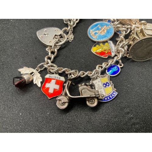 10 - 2 HALLMARKED SILVER CHARM BRACELETS WITH A TOTAL OF 33 SILVER CHARMS TW92.4G
BOTH ENGLISH HALLMARK S... 