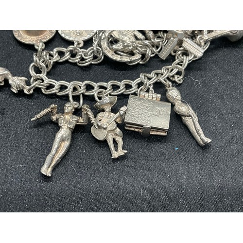 10 - 2 HALLMARKED SILVER CHARM BRACELETS WITH A TOTAL OF 33 SILVER CHARMS TW92.4G
BOTH ENGLISH HALLMARK S... 