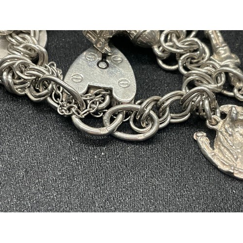 10 - 2 HALLMARKED SILVER CHARM BRACELETS WITH A TOTAL OF 33 SILVER CHARMS TW92.4G
BOTH ENGLISH HALLMARK S... 