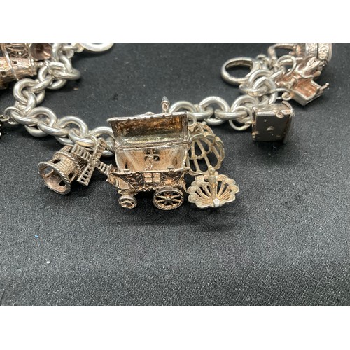11 - SILVER CHARM BRACELET MARKED BUT HEAVILY RUBBED BUT TESTED WITH 9 SILVER CHARMS TW94.1G
