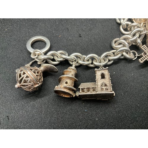 11 - SILVER CHARM BRACELET MARKED BUT HEAVILY RUBBED BUT TESTED WITH 9 SILVER CHARMS TW94.1G