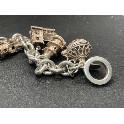11 - SILVER CHARM BRACELET MARKED BUT HEAVILY RUBBED BUT TESTED WITH 9 SILVER CHARMS TW94.1G