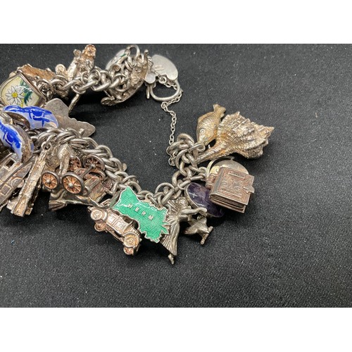 13 - ENGLISH HALLMARKED SILVER LOCKET & CHAIN CHARM BRACELET WITH 45 SILVER & WHITE METAL CHARMS W111.7G