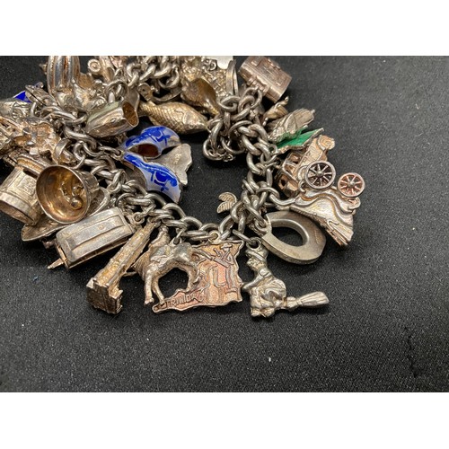 13 - ENGLISH HALLMARKED SILVER LOCKET & CHAIN CHARM BRACELET WITH 45 SILVER & WHITE METAL CHARMS W111.7G