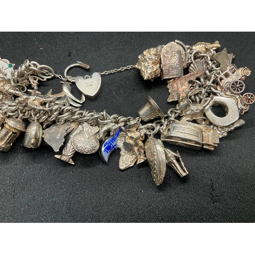13 - ENGLISH HALLMARKED SILVER LOCKET & CHAIN CHARM BRACELET WITH 45 SILVER & WHITE METAL CHARMS W111.7G