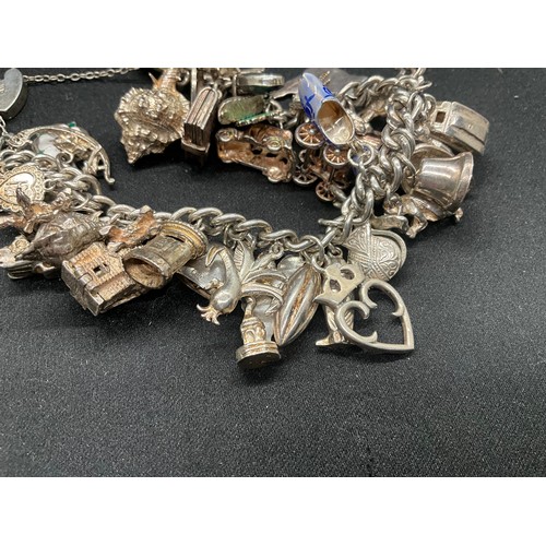 13 - ENGLISH HALLMARKED SILVER LOCKET & CHAIN CHARM BRACELET WITH 45 SILVER & WHITE METAL CHARMS W111.7G