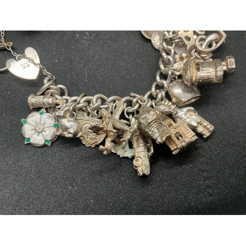 13 - ENGLISH HALLMARKED SILVER LOCKET & CHAIN CHARM BRACELET WITH 45 SILVER & WHITE METAL CHARMS W111.7G
