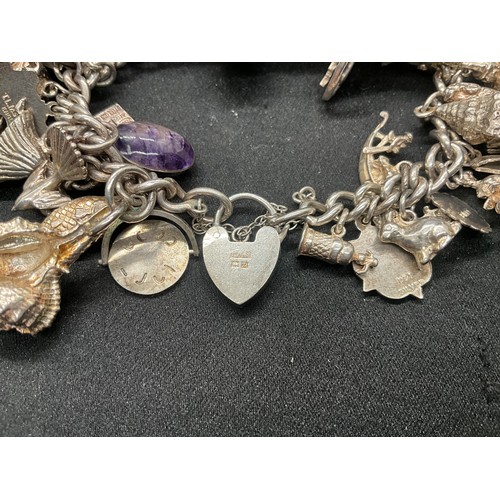 13 - ENGLISH HALLMARKED SILVER LOCKET & CHAIN CHARM BRACELET WITH 45 SILVER & WHITE METAL CHARMS W111.7G