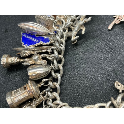 13 - ENGLISH HALLMARKED SILVER LOCKET & CHAIN CHARM BRACELET WITH 45 SILVER & WHITE METAL CHARMS W111.7G