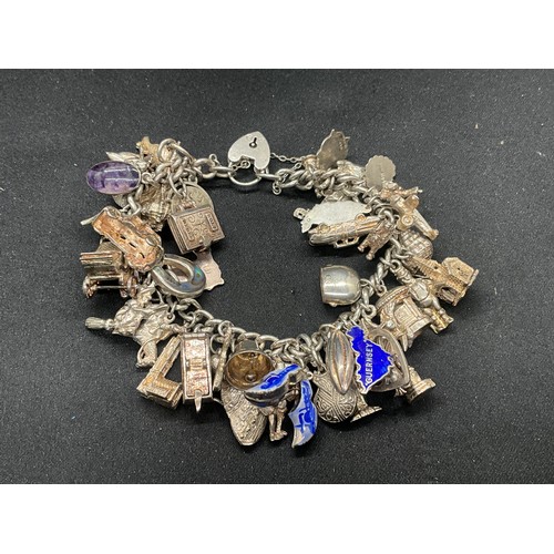 13 - ENGLISH HALLMARKED SILVER LOCKET & CHAIN CHARM BRACELET WITH 45 SILVER & WHITE METAL CHARMS W111.7G