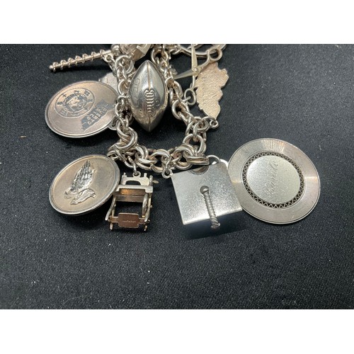 14 - STERLING SILVER CHARM BRACELET WITH 14 SILVER CHARMS TW75.7G - ADDITIONAL 3 CHARMS NOT SILVER