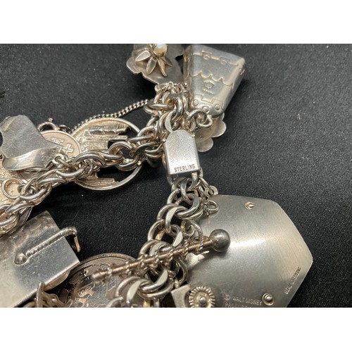 14 - STERLING SILVER CHARM BRACELET WITH 14 SILVER CHARMS TW75.7G - ADDITIONAL 3 CHARMS NOT SILVER