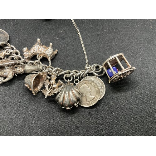 16 - SILVER CHARM BRACELET HALLMARKED WITH 27 SILVER CHARMS AND 1 ADDITIONAL CHARM NOT SILVER TW91.6G - I... 