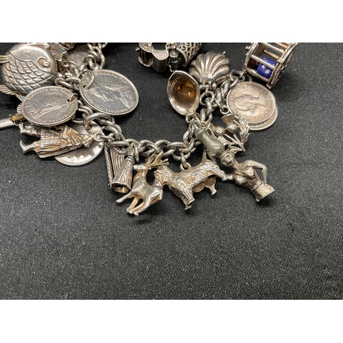 16 - SILVER CHARM BRACELET HALLMARKED WITH 27 SILVER CHARMS AND 1 ADDITIONAL CHARM NOT SILVER TW91.6G - I... 