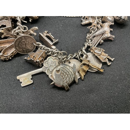 16 - SILVER CHARM BRACELET HALLMARKED WITH 27 SILVER CHARMS AND 1 ADDITIONAL CHARM NOT SILVER TW91.6G - I... 