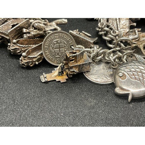 16 - SILVER CHARM BRACELET HALLMARKED WITH 27 SILVER CHARMS AND 1 ADDITIONAL CHARM NOT SILVER TW91.6G - I... 
