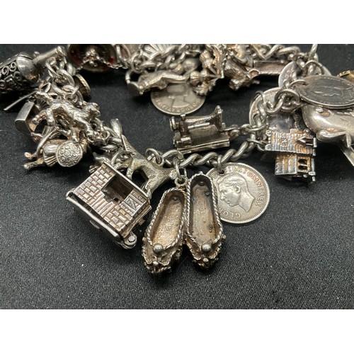 16 - SILVER CHARM BRACELET HALLMARKED WITH 27 SILVER CHARMS AND 1 ADDITIONAL CHARM NOT SILVER TW91.6G - I... 