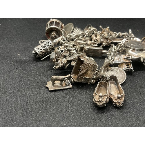 16 - SILVER CHARM BRACELET HALLMARKED WITH 27 SILVER CHARMS AND 1 ADDITIONAL CHARM NOT SILVER TW91.6G - I... 