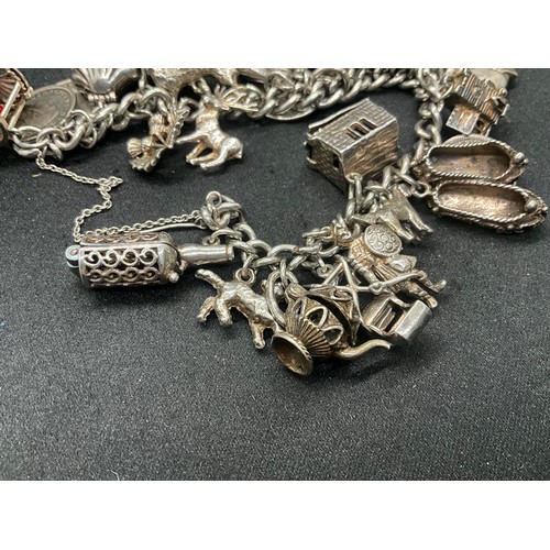 16 - SILVER CHARM BRACELET HALLMARKED WITH 27 SILVER CHARMS AND 1 ADDITIONAL CHARM NOT SILVER TW91.6G - I... 
