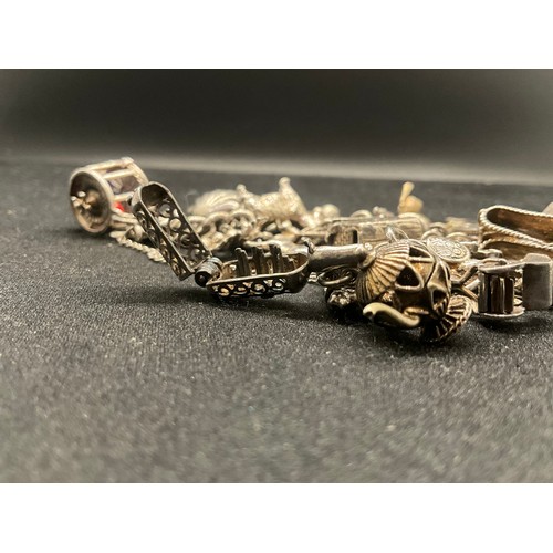16 - SILVER CHARM BRACELET HALLMARKED WITH 27 SILVER CHARMS AND 1 ADDITIONAL CHARM NOT SILVER TW91.6G - I... 