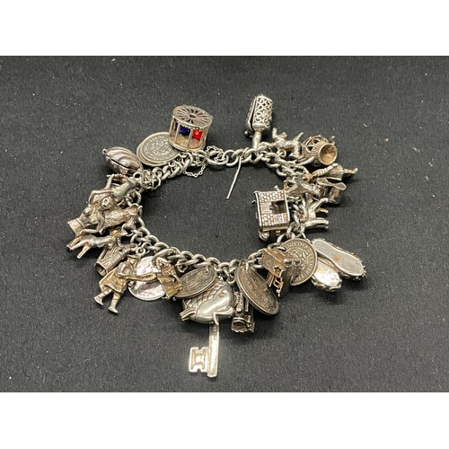 16 - SILVER CHARM BRACELET HALLMARKED WITH 27 SILVER CHARMS AND 1 ADDITIONAL CHARM NOT SILVER TW91.6G - I... 