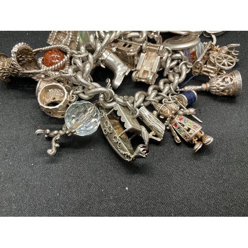 23 - HALLMARKED SILVER CHARM BRACELET WITH 23 SILVER & WHITE METAL CHARMS W113.8G - LOCKET IS CONTINENTAL... 