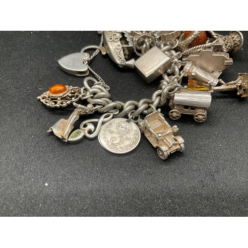 23 - HALLMARKED SILVER CHARM BRACELET WITH 23 SILVER & WHITE METAL CHARMS W113.8G - LOCKET IS CONTINENTAL... 